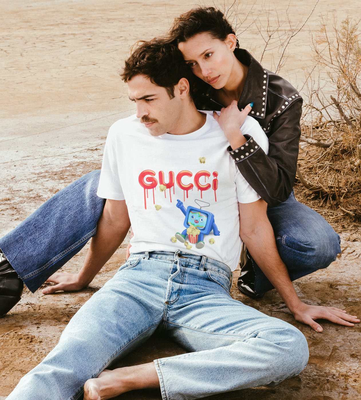 Gucci TV: a TV character eating popcorn under dripping Gucci lettering, printed on a T-shirt in a desert fashion shoot
