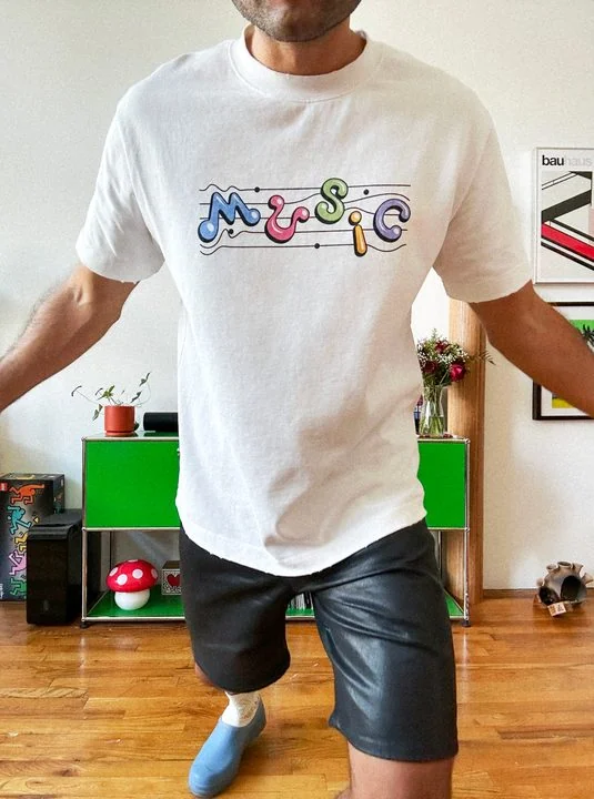The white Music Tee worn at home, front.