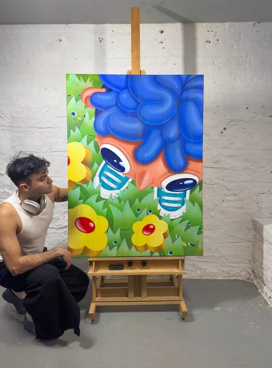 Carlos Miranda painting Walking on Grass on the easel in the studio.